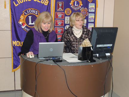 Lions Cindy Costa and Donna McMullin serving as auctioneers